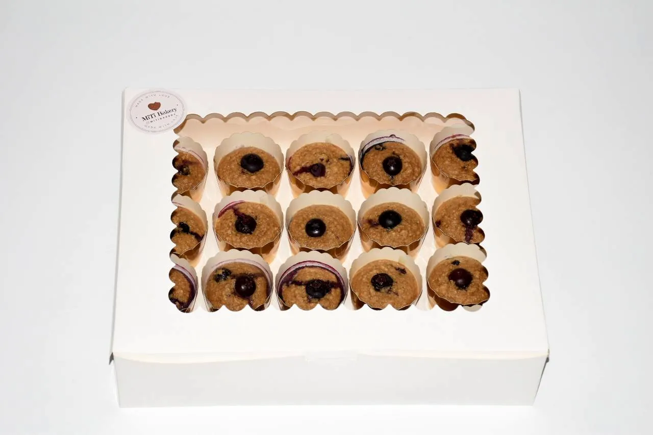 Blueberry oat muffins arranged in a white window box